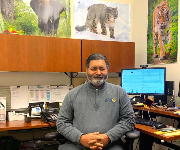 Sunil Chacko at his desk in the Residential Student Services Building