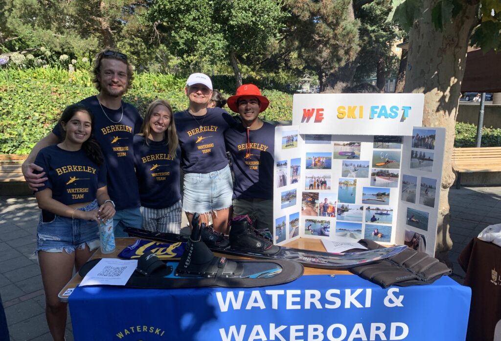 Berkeley Water Ski and Wakeboard members smiling behind their table.