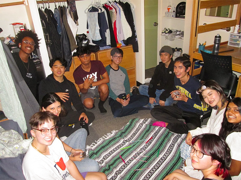 Nina (front left) and his floormates have a game night.