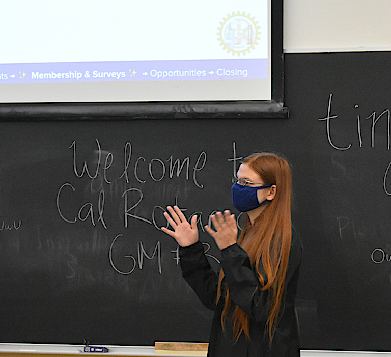 Student in mask giving a presentation.