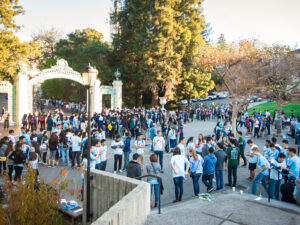 Student volunteers with the Berkeley Project gather in front of Sather Gate on campus.